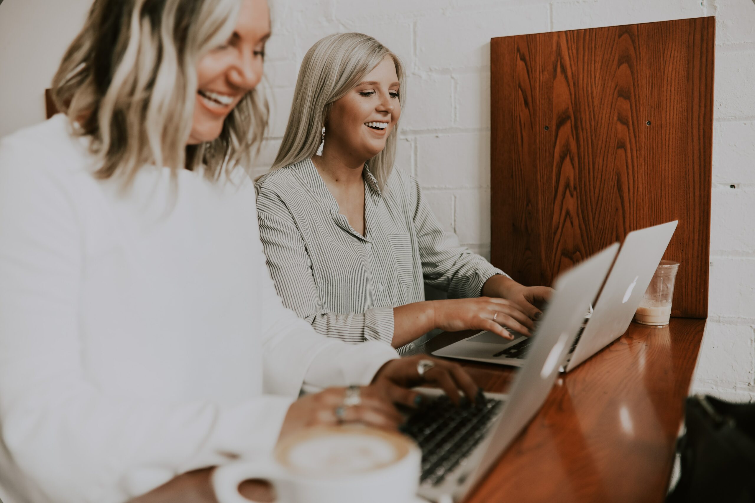 two women in a cafe with their laptops